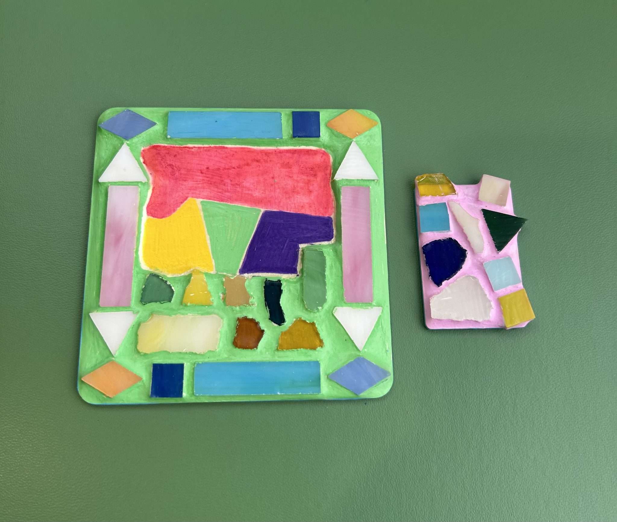 Two colourful mixed-media relief artworks featuring abstract geometric shapes and translucent materials. Bright colours, layered textures and mosaic-like compositions explore creativity, pattern and personal expression through shape and colour.