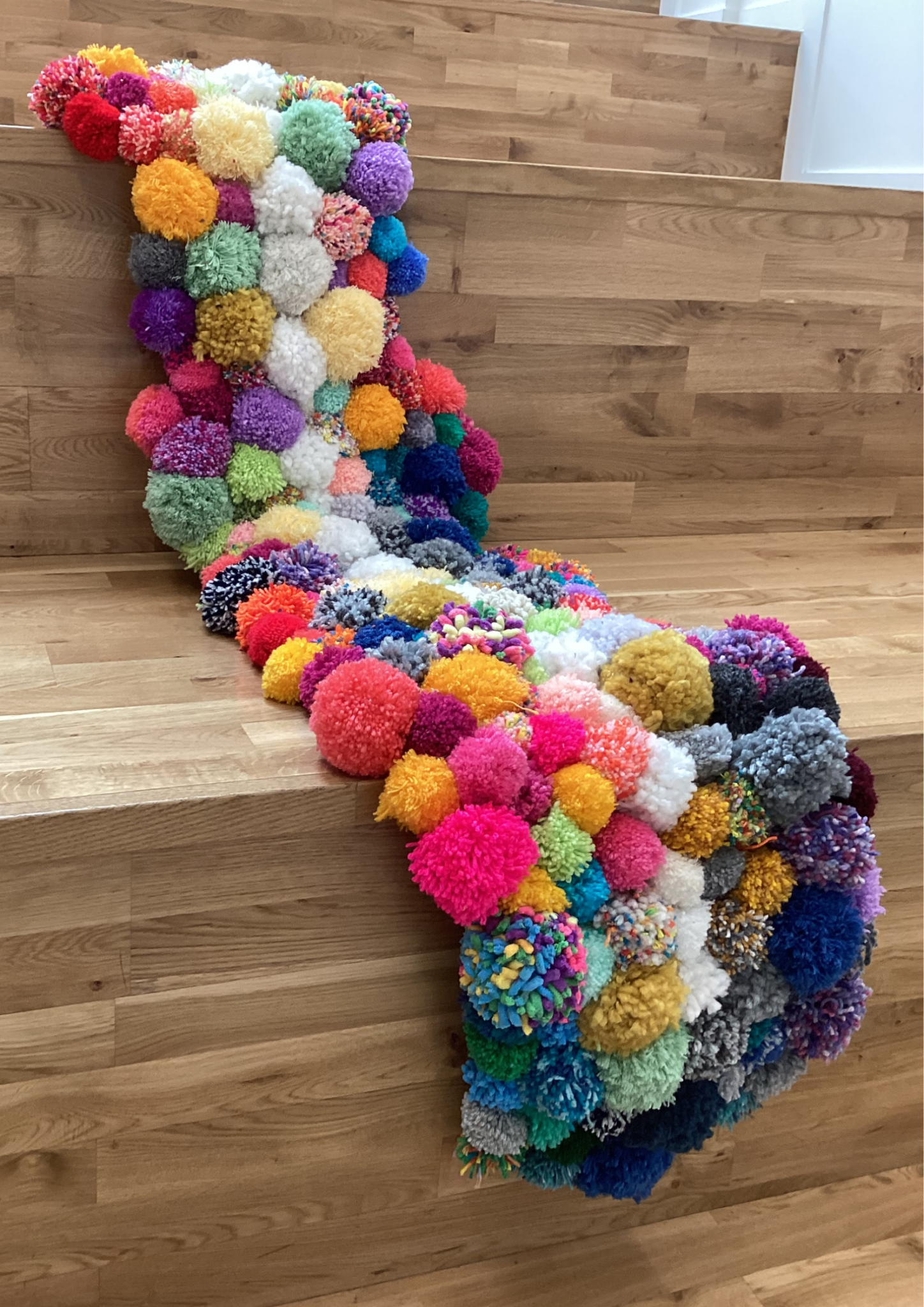 Textile. 24 cream coloured pom poms to represent the 24 vertebrae in adult human. 220 unique patterned colour pom poms to represent the 220,000 people in the UK with Ankylosing Spondilitis