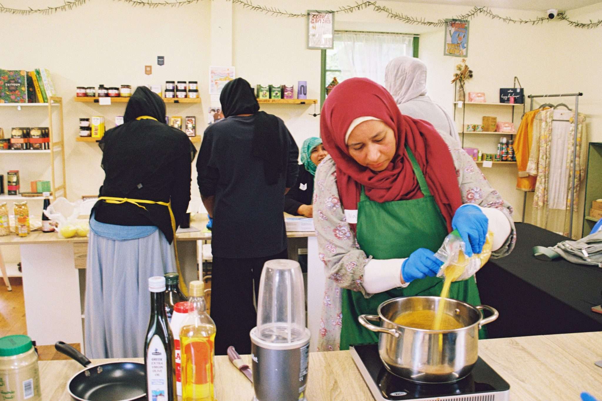 Three women cooking in a kitchen.